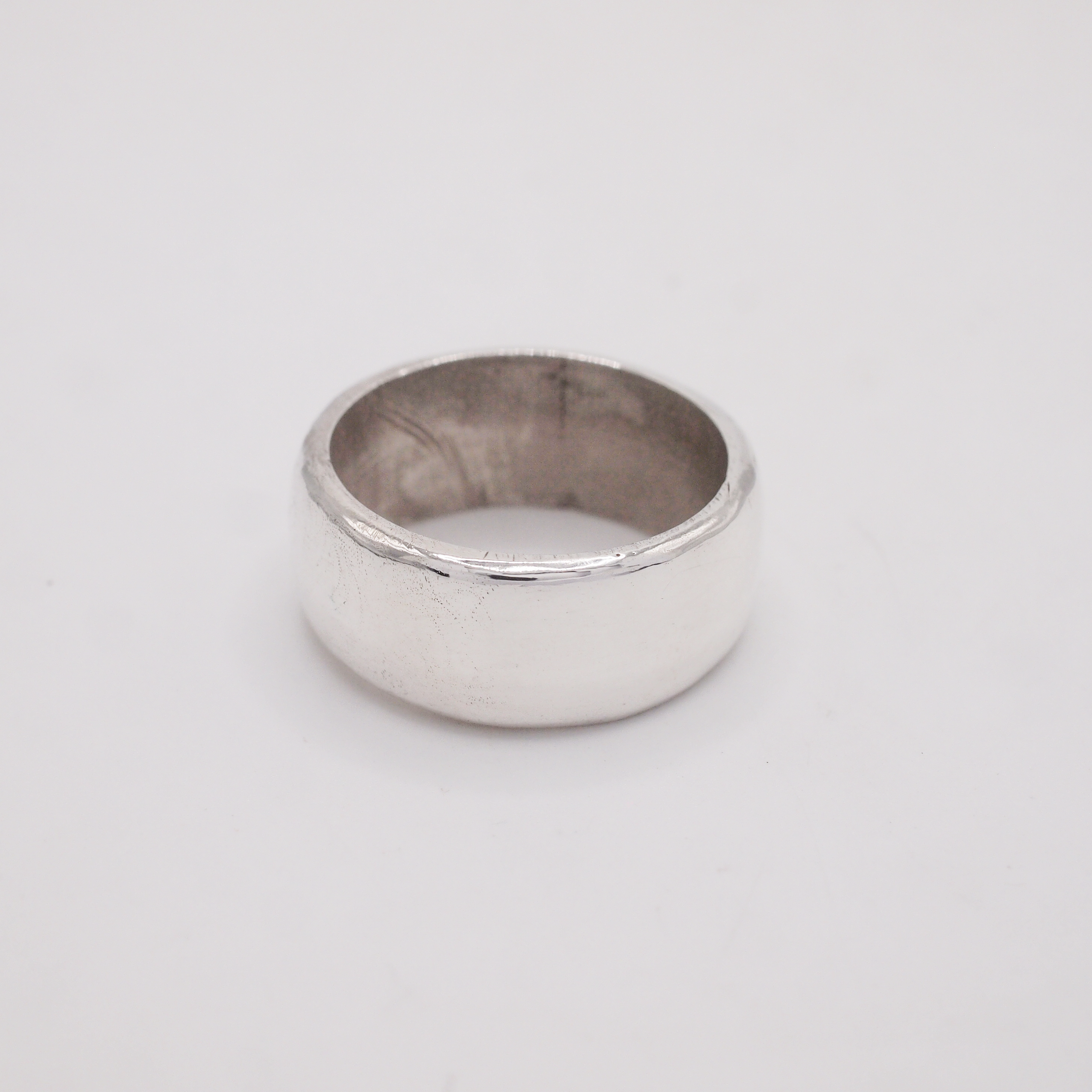Silver ring on a light gray background